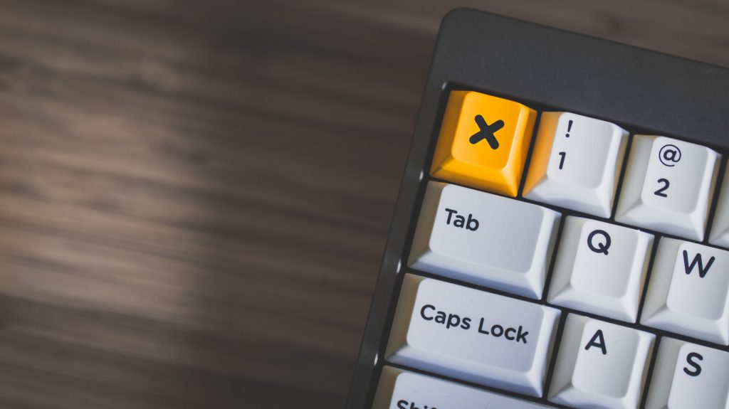 Keyboard with a yellow key with an X on it.